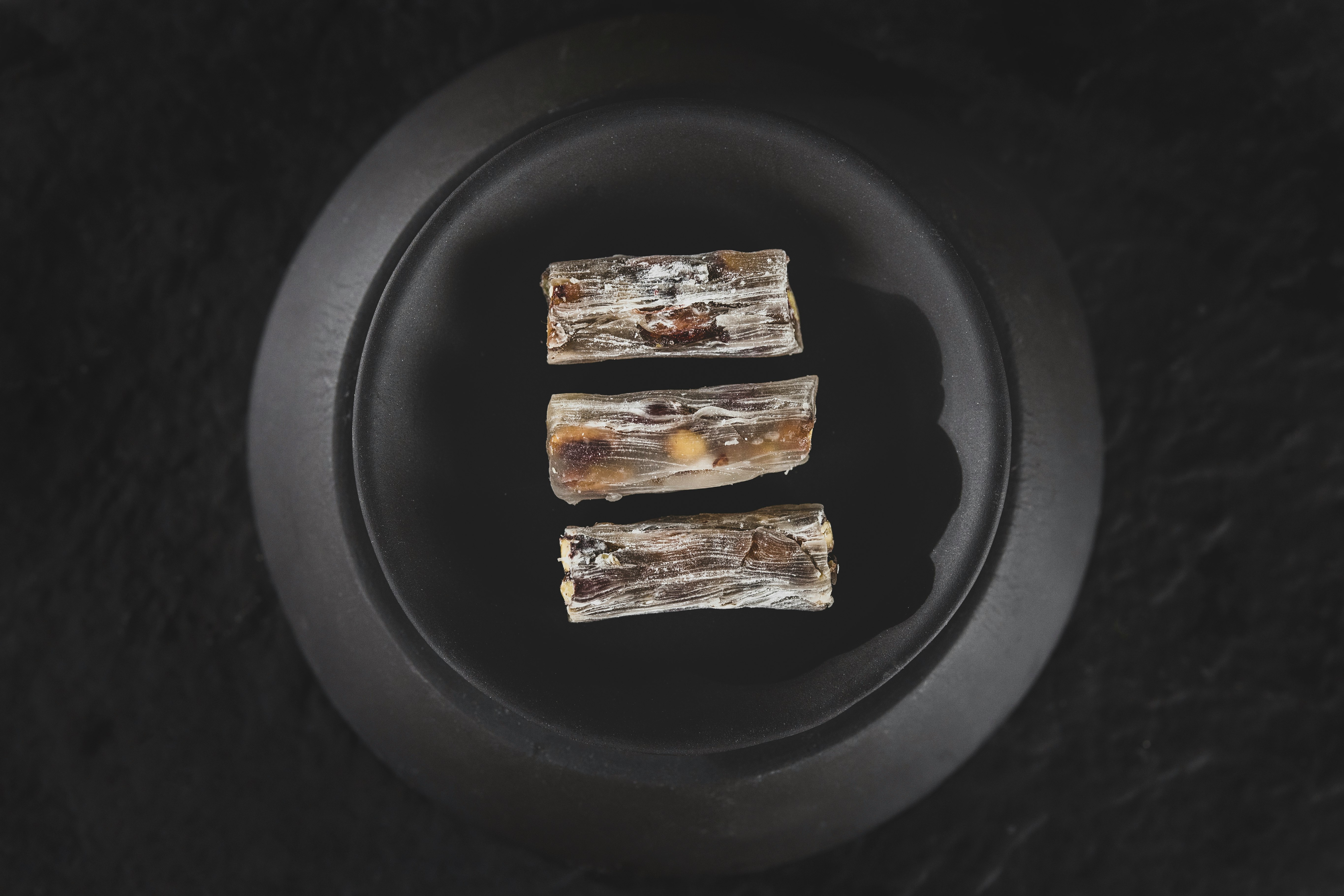 2 brown and white food on black plate